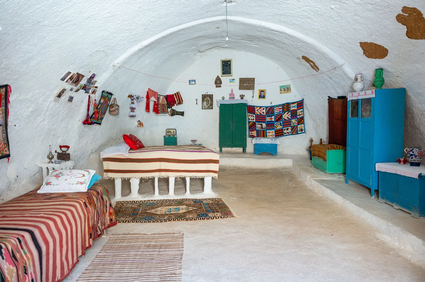 The whitewashed interior of a Sacromonte cave hung with copper pans