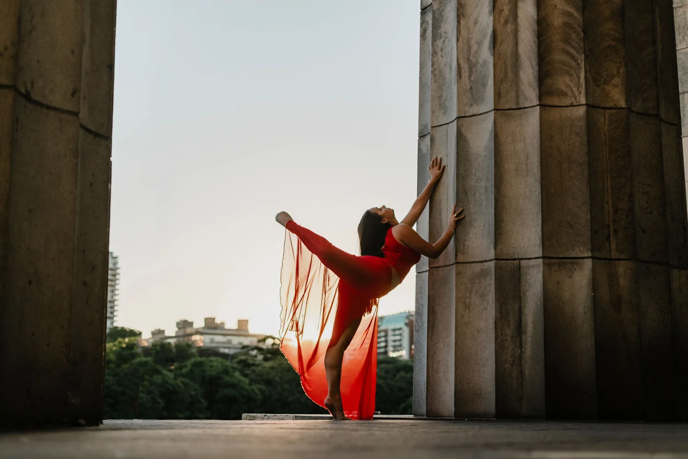 A flamenco dancer in a ruffled dress mid-movement in a cave