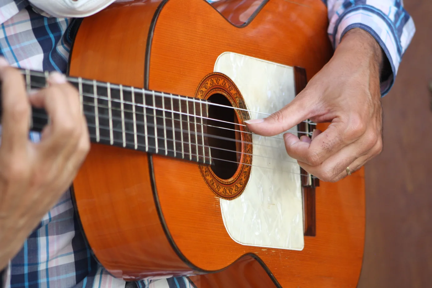 A flamenco guitarist playing inside a whitewashed cave